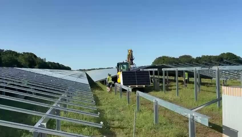 COH crew placing photovoltaic modules with a crane